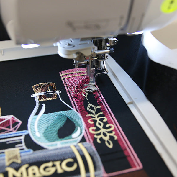 Machine embroidery bookshelf design under an embroidery machine