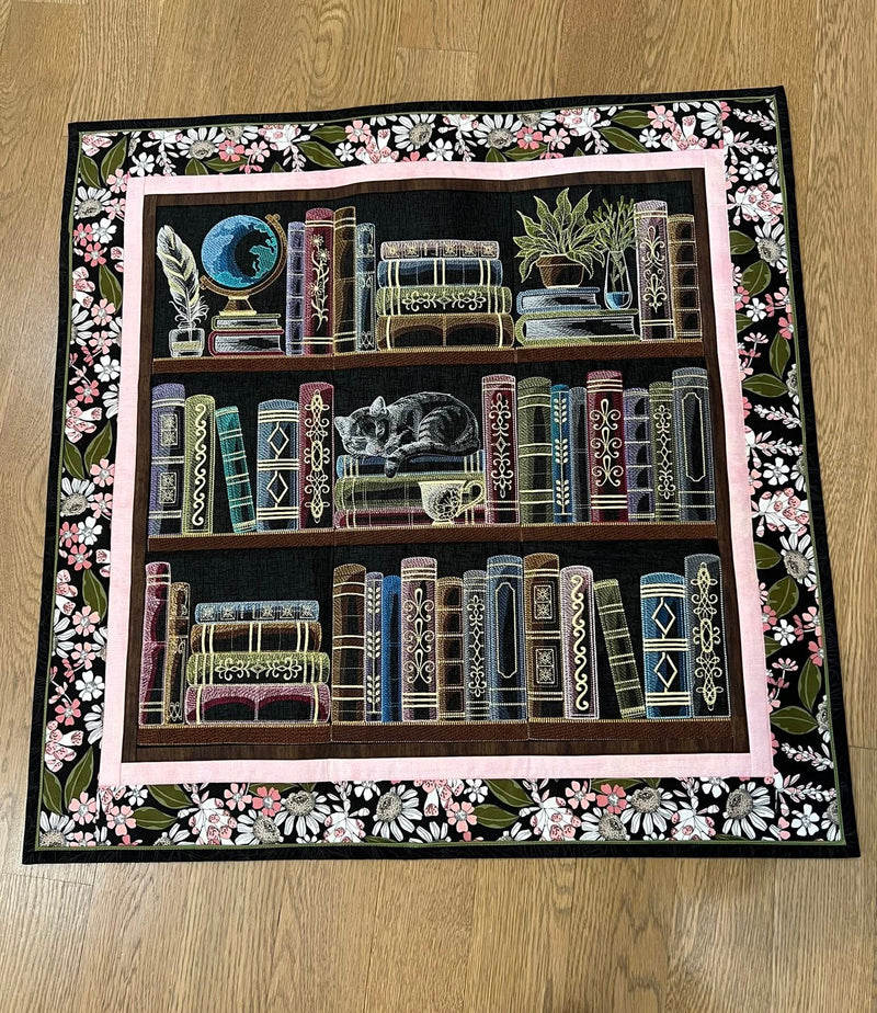 Decorative machine embroidery bookshelf panel designs with floral border on a wooden floor.