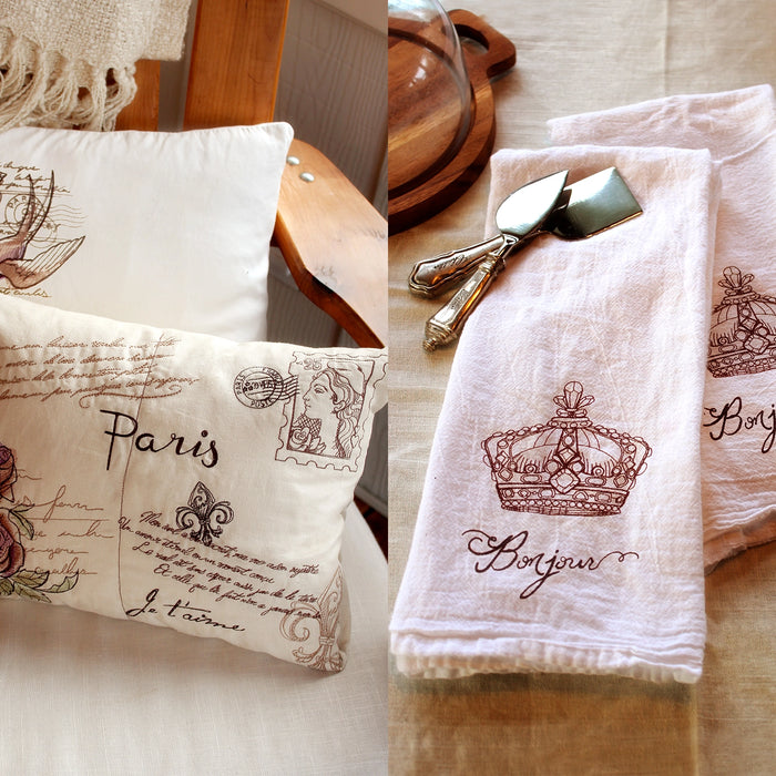 machine embroidery Parisian-inspired designs on white pillows and tea towels. 