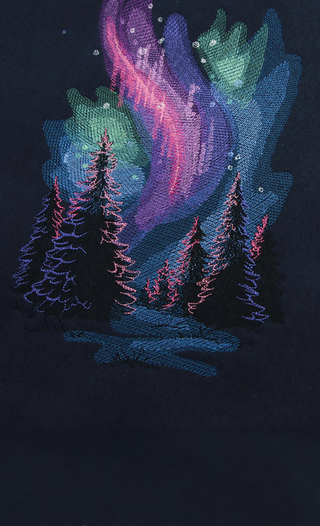 Machine embroidery Aurora borealis design on blue fabric