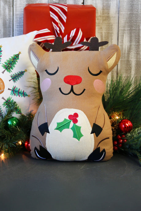 Decorative machine embroidery reindeer plush with Christmas decorations in the background