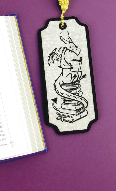 Machine embroidery bookmark with a dragon design on a purple background