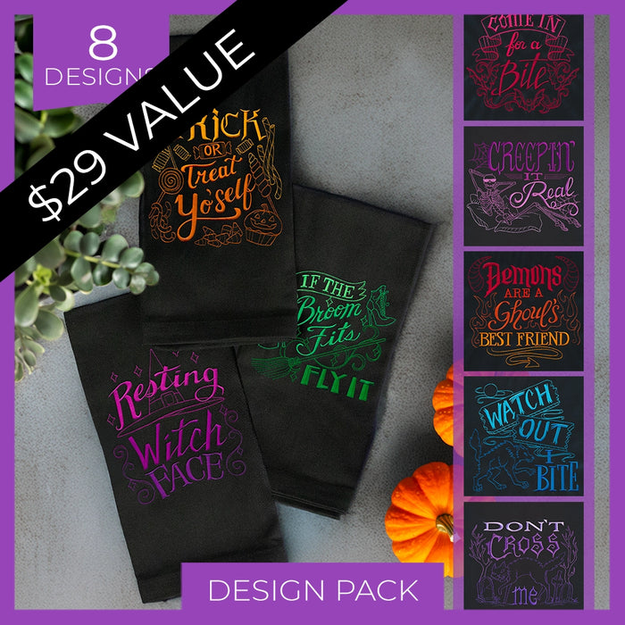 Black Towels with Halloween-themed machine embroidery designs and text, displayed with pumpkins and plants on a gray surface.