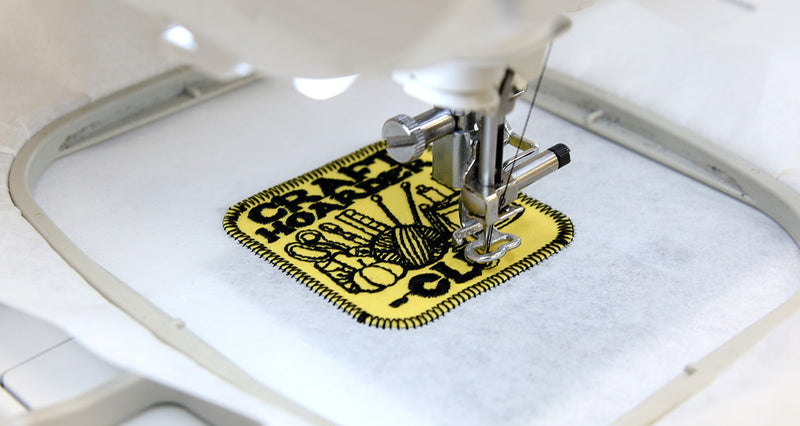 Embroidery machine stitching a design on fabric